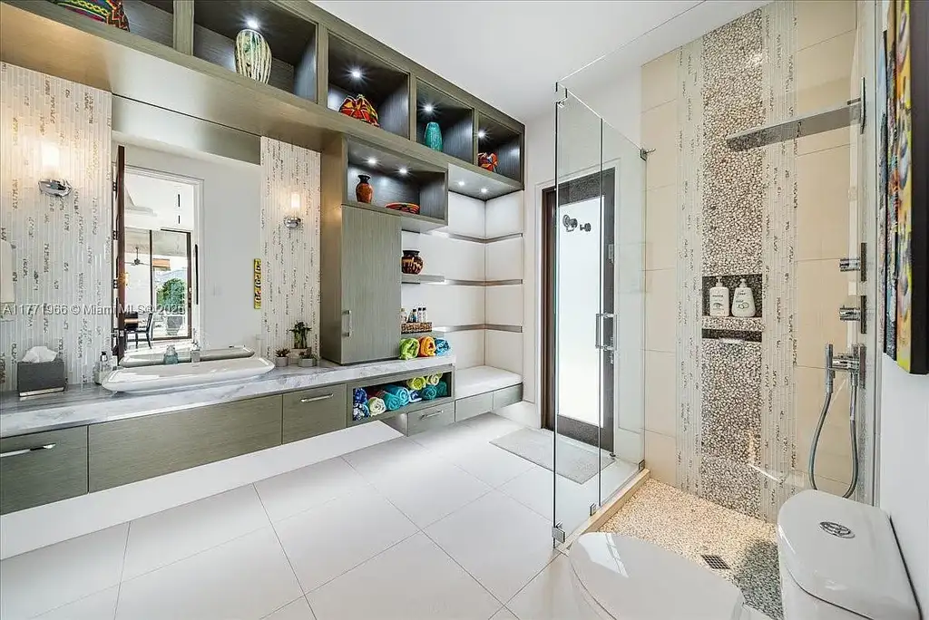 Luxurious waterfront mansion at 20 Compass Isle in Fort Lauderdale with tropical landscaping and gated driveway