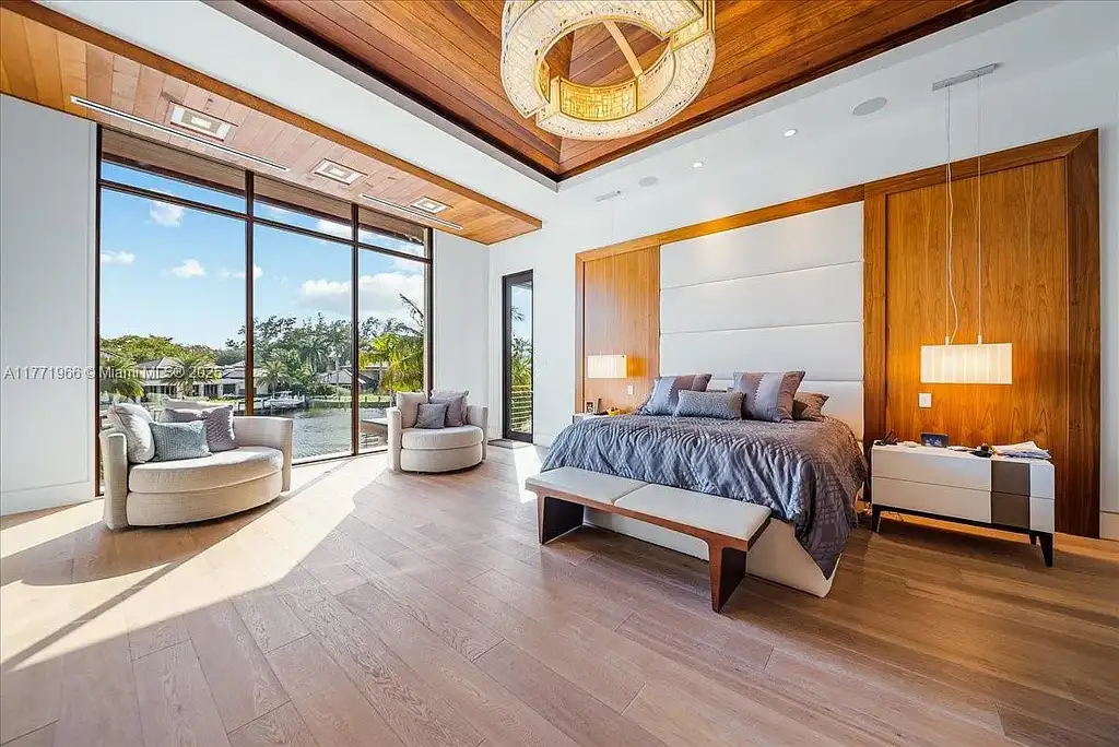 Luxurious waterfront mansion at 20 Compass Isle in Fort Lauderdale with tropical landscaping and gated driveway
