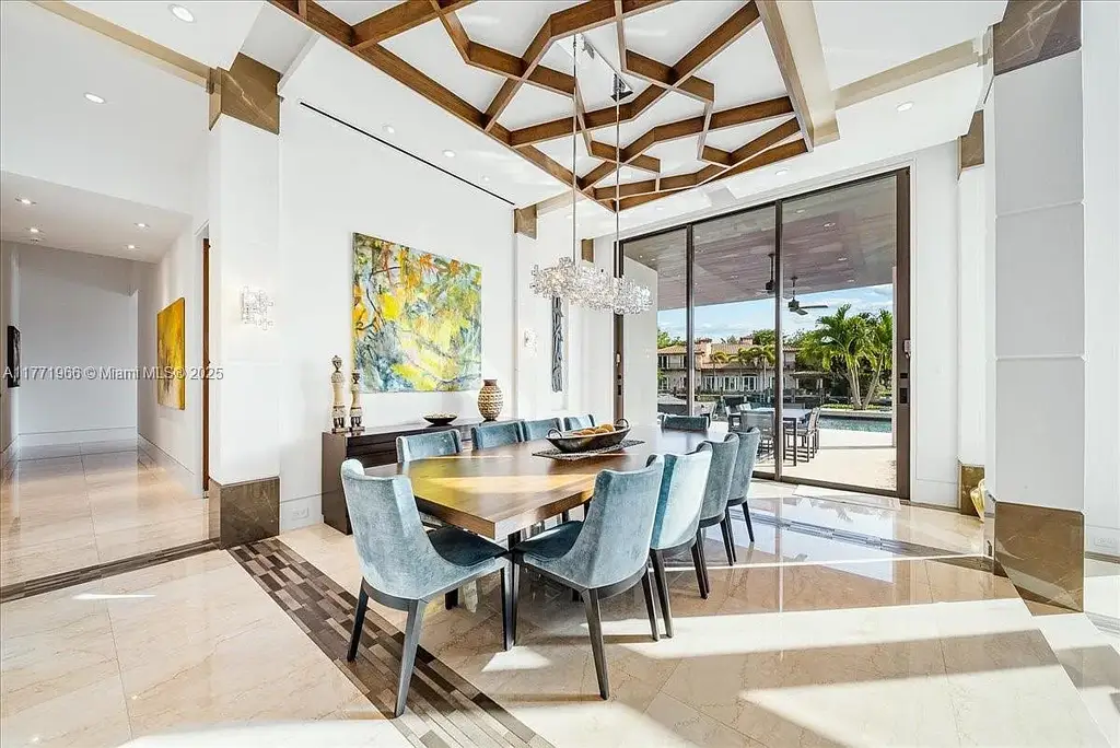 Luxurious waterfront mansion at 20 Compass Isle in Fort Lauderdale with tropical landscaping and gated driveway