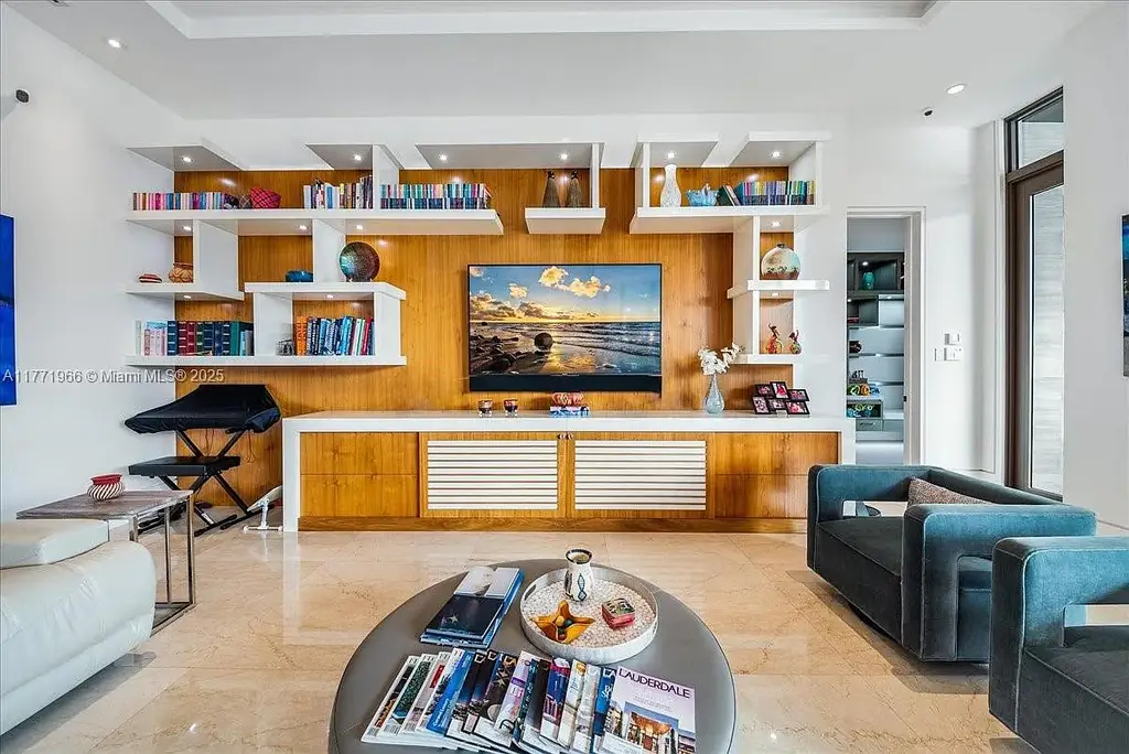 Luxurious waterfront mansion at 20 Compass Isle in Fort Lauderdale with tropical landscaping and gated driveway