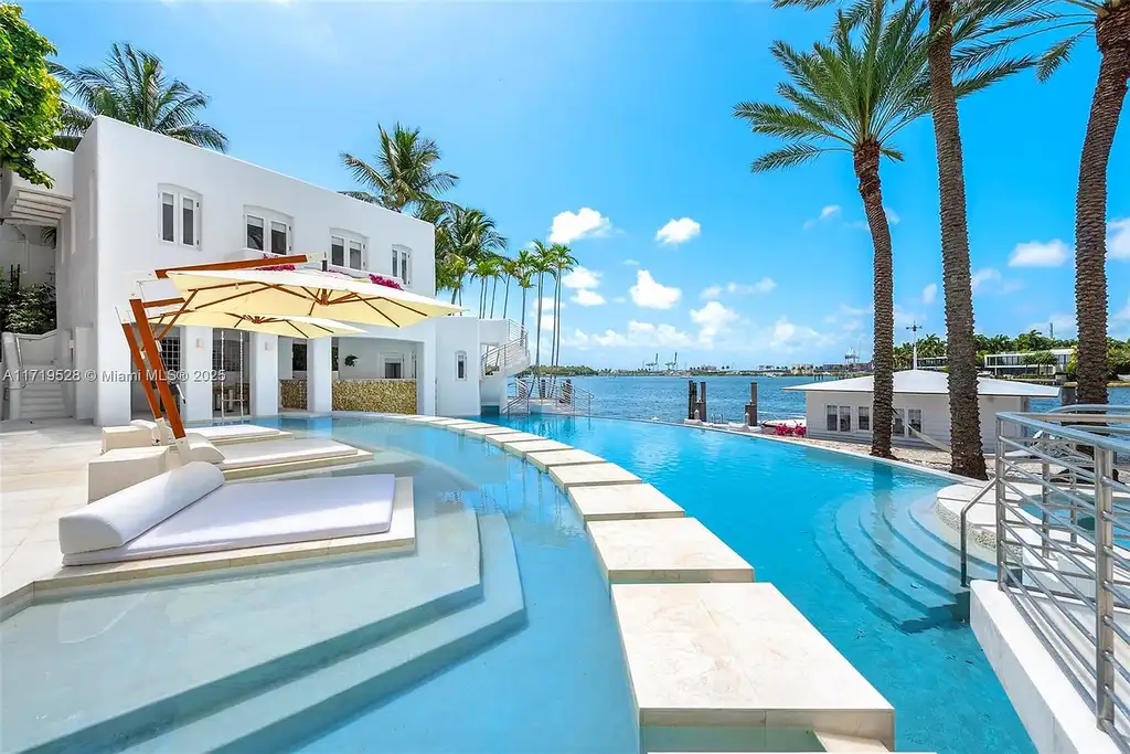 Luxury waterfront villa at 24 S Hibiscus Dr in Miami Beach with rooftop terraces, over-water dock, and two-level pool
