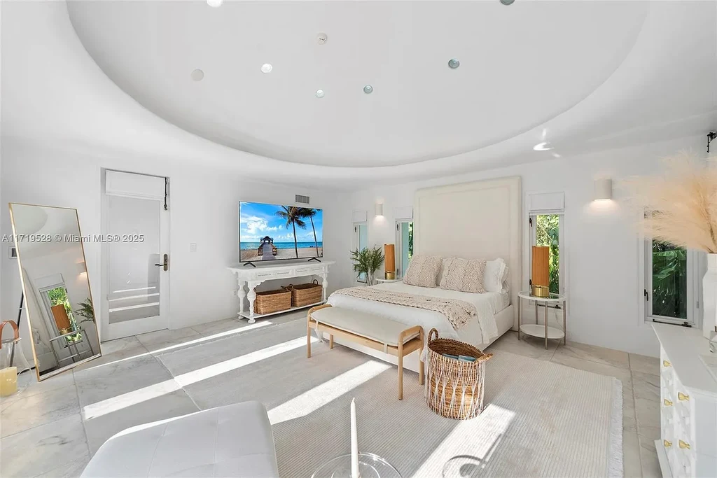 Luxury waterfront villa at 24 S Hibiscus Dr in Miami Beach with rooftop terraces, over-water dock, and two-level pool