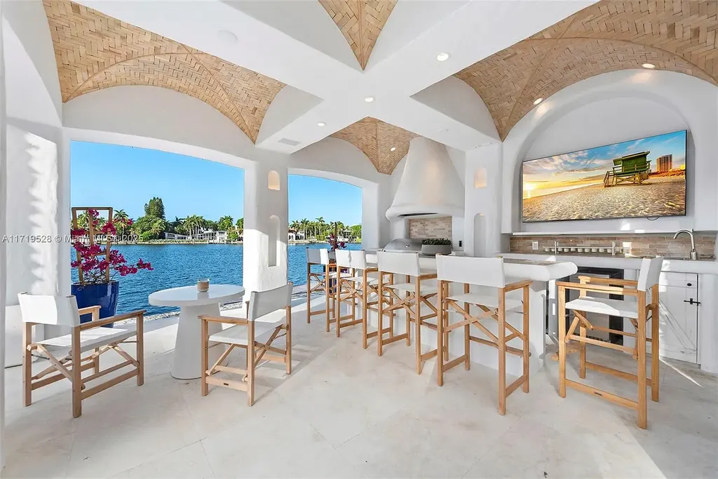 Luxury waterfront villa at 24 S Hibiscus Dr in Miami Beach with rooftop terraces, over-water dock, and two-level pool