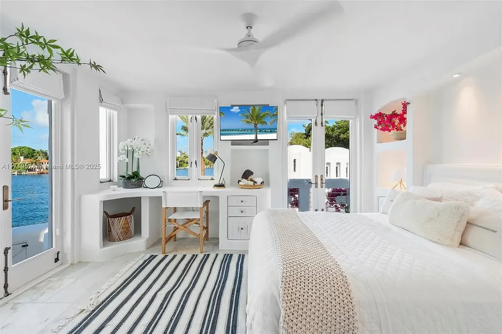 Luxury waterfront villa at 24 S Hibiscus Dr in Miami Beach with rooftop terraces, over-water dock, and two-level pool