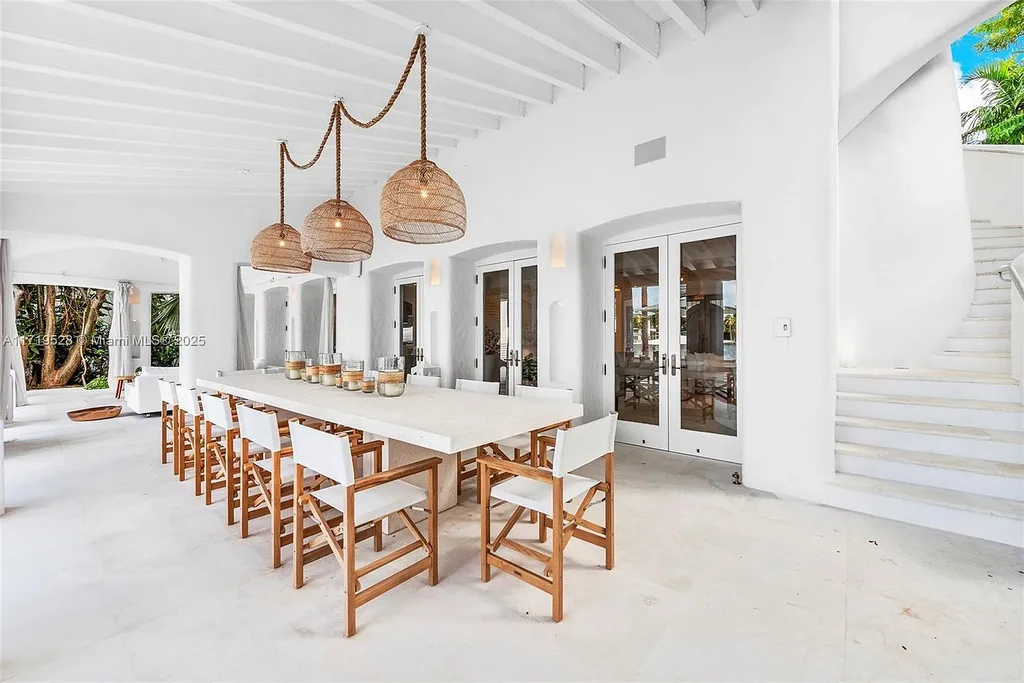 Luxury waterfront villa at 24 S Hibiscus Dr in Miami Beach with rooftop terraces, over-water dock, and two-level pool