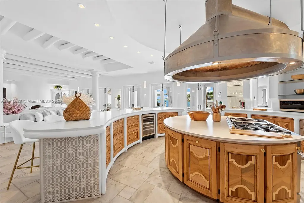 Luxury waterfront villa at 24 S Hibiscus Dr in Miami Beach with rooftop terraces, over-water dock, and two-level pool