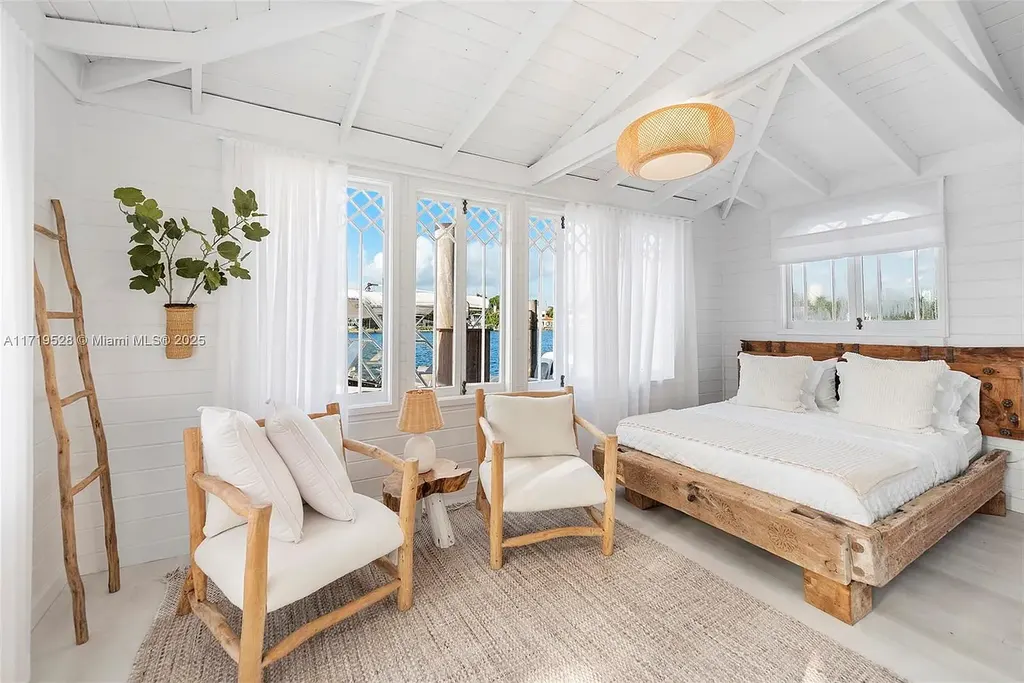Luxury waterfront villa at 24 S Hibiscus Dr in Miami Beach with rooftop terraces, over-water dock, and two-level pool