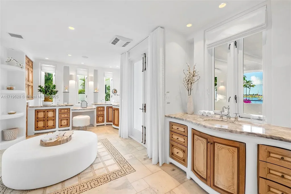 Luxury waterfront villa at 24 S Hibiscus Dr in Miami Beach with rooftop terraces, over-water dock, and two-level pool