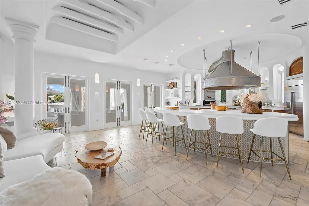 Luxury waterfront villa at 24 S Hibiscus Dr in Miami Beach with rooftop terraces, over-water dock, and two-level pool