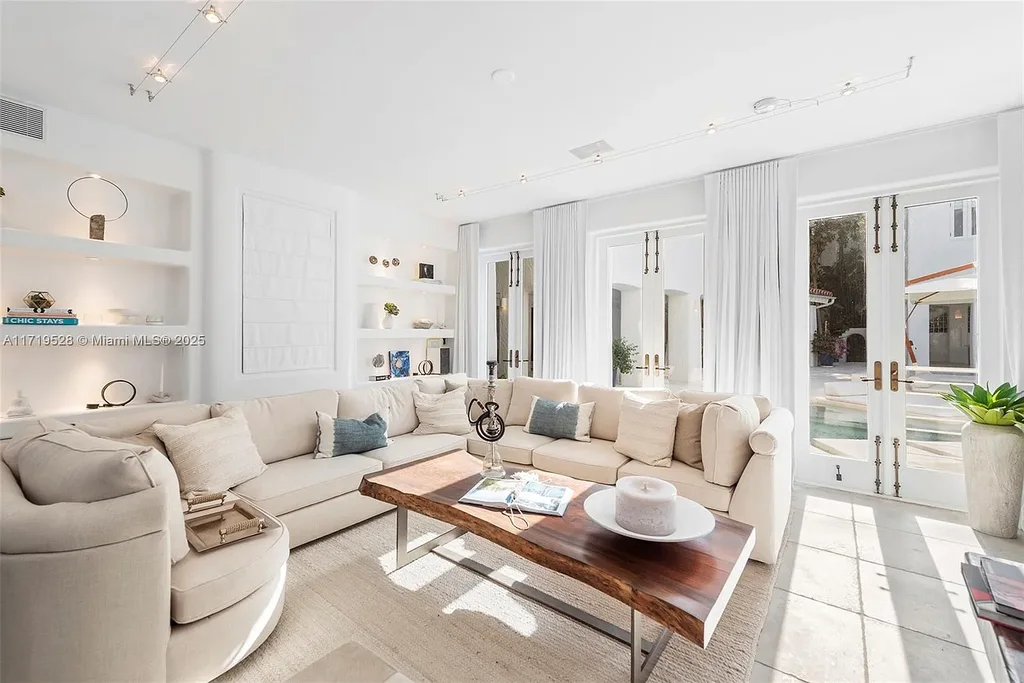 Luxury waterfront villa at 24 S Hibiscus Dr in Miami Beach with rooftop terraces, over-water dock, and two-level pool