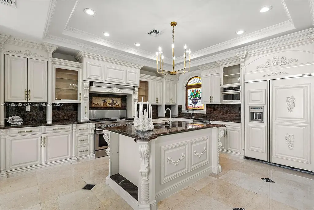 Gourmet kitchen in 270 Atlantic Ave Sunny Isles Beach home with Australian green marble floors and premium appliances