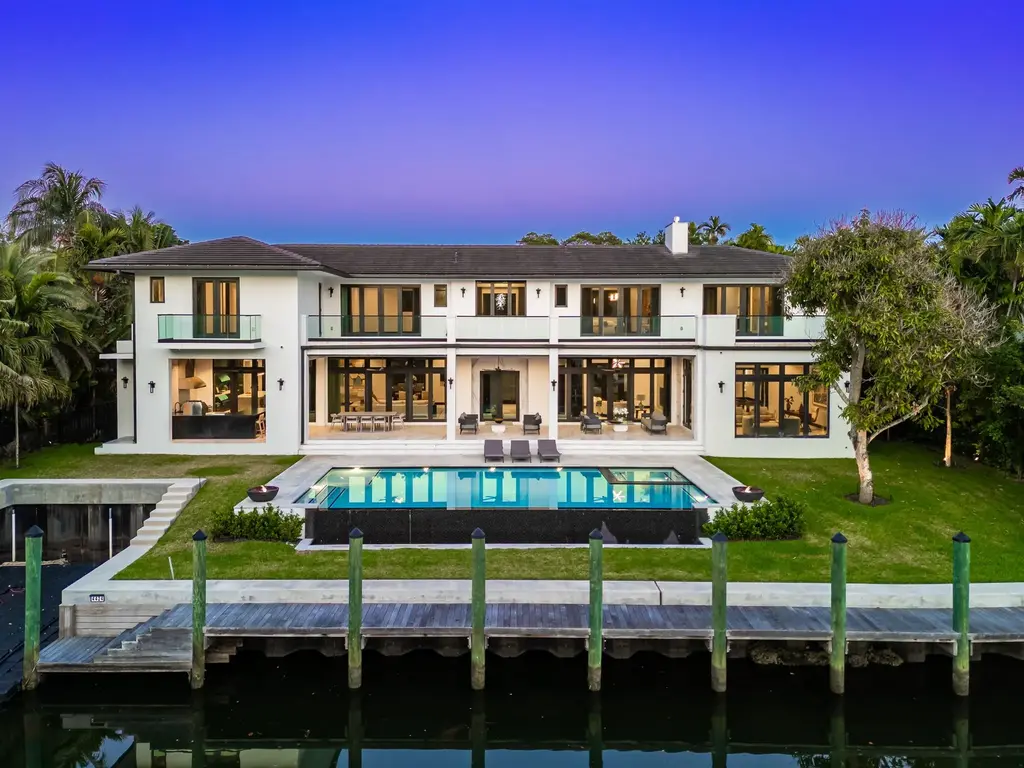 Infinity-edge pool and backyard oasis with canal views at 4424 Granada Blvd Coral Gables home for sale