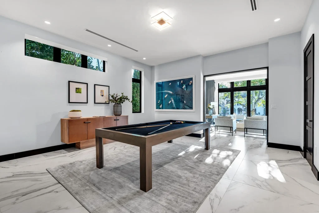 Infinity-edge pool and backyard oasis with canal views at 4424 Granada Blvd Coral Gables home for sale