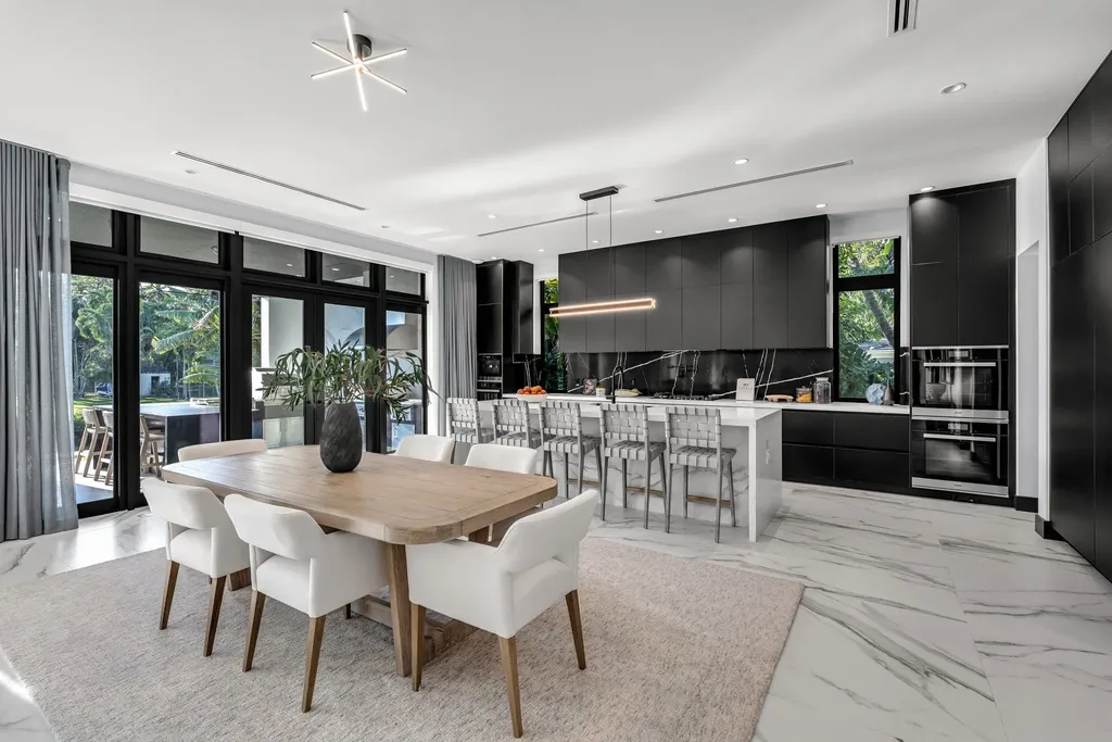 Infinity-edge pool and backyard oasis with canal views at 4424 Granada Blvd Coral Gables home for sale