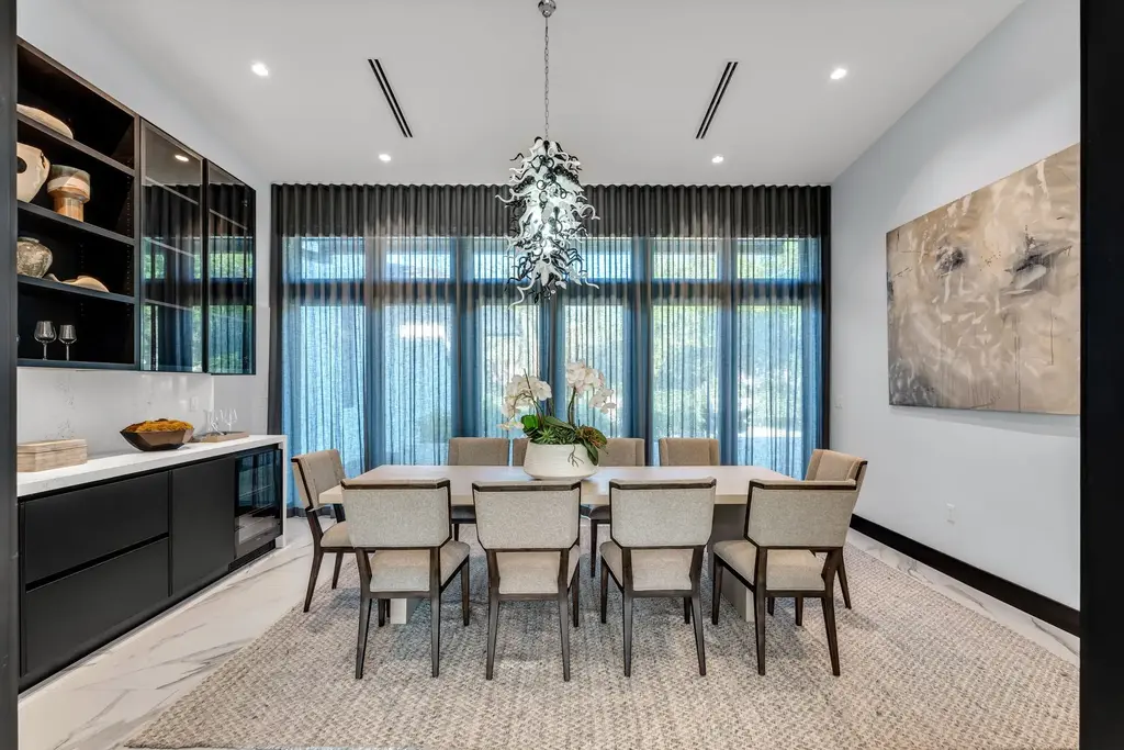 Infinity-edge pool and backyard oasis with canal views at 4424 Granada Blvd Coral Gables home for sale