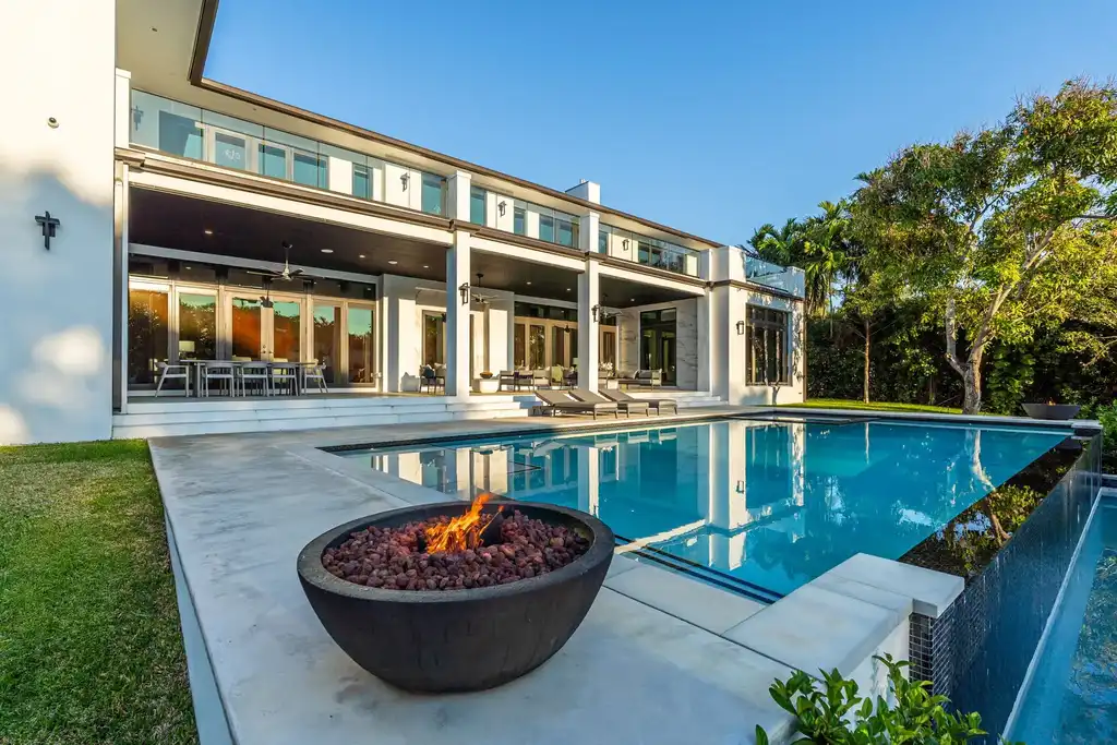 Infinity-edge pool and backyard oasis with canal views at 4424 Granada Blvd Coral Gables home for sale