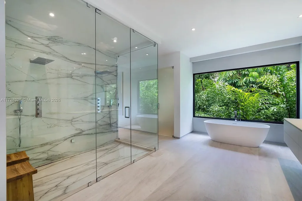 Luxury pool area surrounded by lush landscaping at 5400 Hammock Dr in Coral Gables Real Estate.