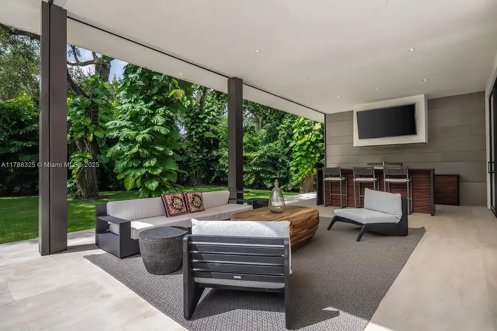 Luxury pool area surrounded by lush landscaping at 5400 Hammock Dr in Coral Gables Real Estate.