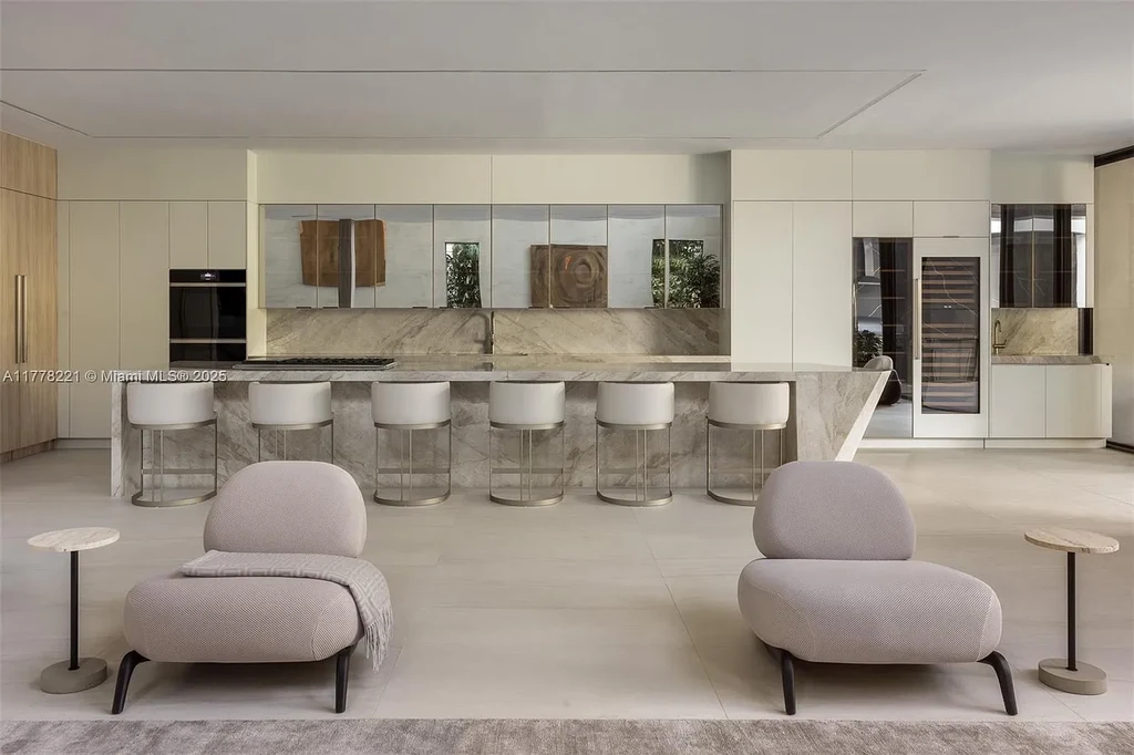 Luxury waterfront home at 725 NE 77th St, Miami featuring private dock, heated pool, modern architecture, and lush landscaping in Belle Meade