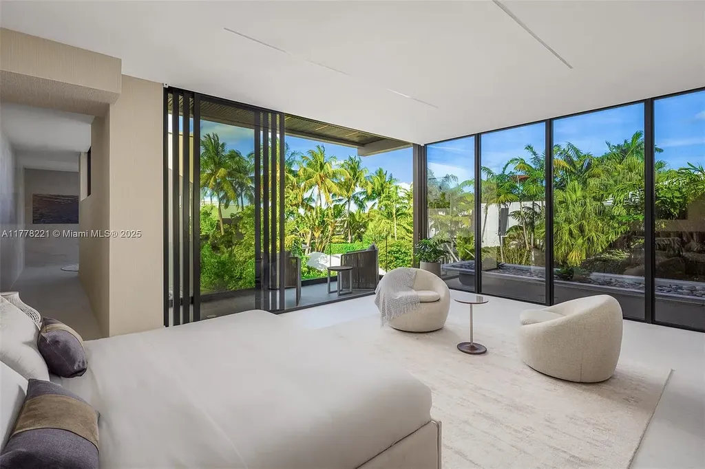 Luxury waterfront home at 725 NE 77th St, Miami featuring private dock, heated pool, modern architecture, and lush landscaping in Belle Meade
