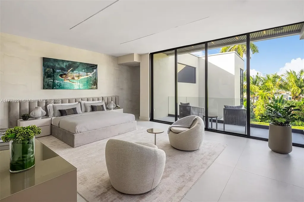 Luxury waterfront home at 725 NE 77th St, Miami featuring private dock, heated pool, modern architecture, and lush landscaping in Belle Meade