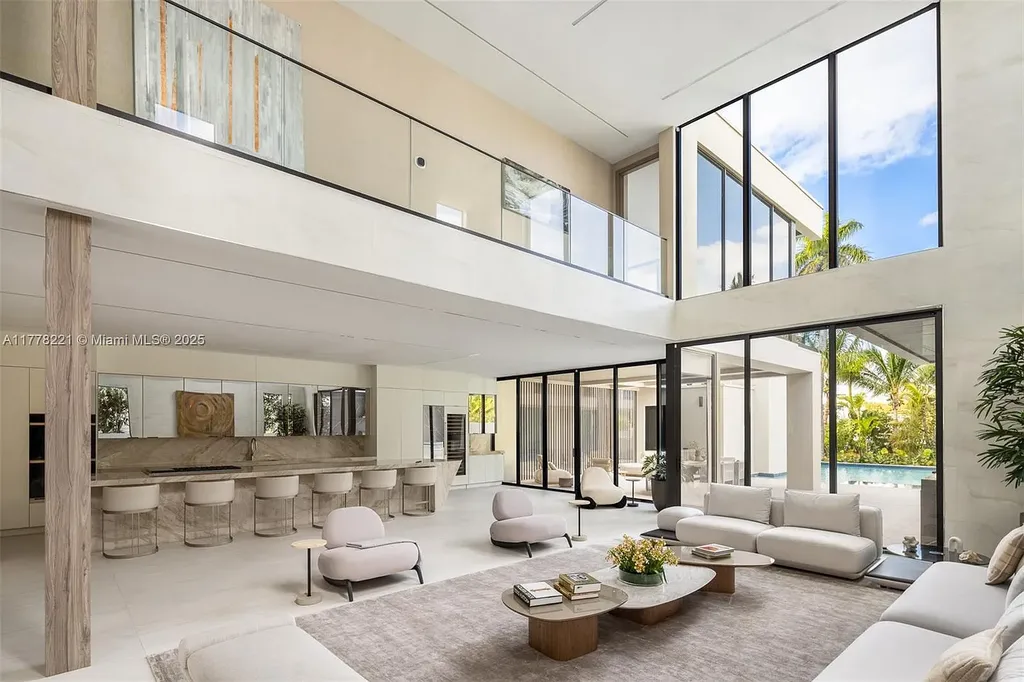 Luxury waterfront home at 725 NE 77th St, Miami featuring private dock, heated pool, modern architecture, and lush landscaping in Belle Meade