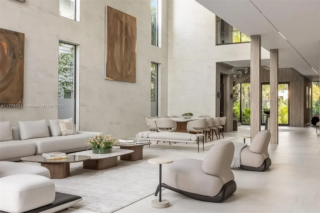 Luxury waterfront home at 725 NE 77th St, Miami featuring private dock, heated pool, modern architecture, and lush landscaping in Belle Meade