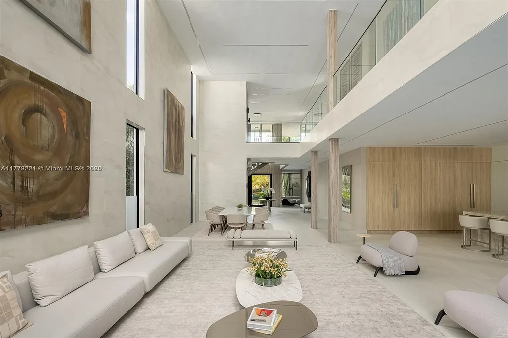 Luxury waterfront home at 725 NE 77th St, Miami featuring private dock, heated pool, modern architecture, and lush landscaping in Belle Meade