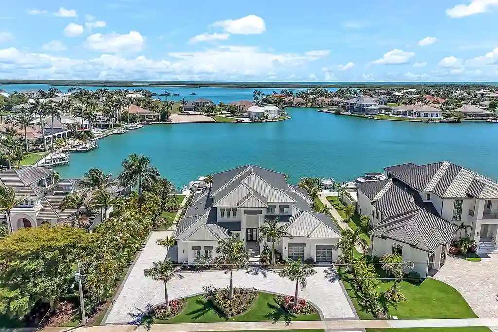 Front view of 1761 Ludlow Rd showcasing modern coastal architecture and lush landscaping in Marco Island.