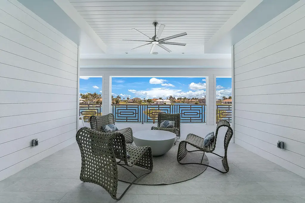 Front view of 1761 Ludlow Rd showcasing modern coastal architecture and lush landscaping in Marco Island.