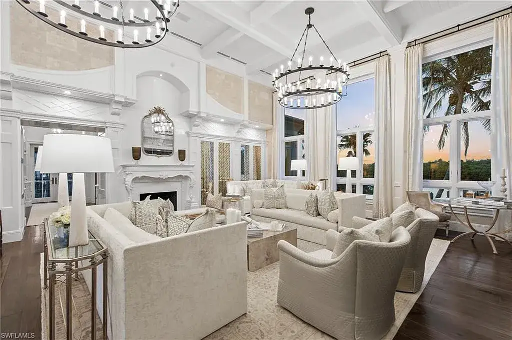 3675 Gordon Dr luxury home in Naples featuring French West Indies design, private beach access, koi pond, resort-style pool, and Gulf-access dock.