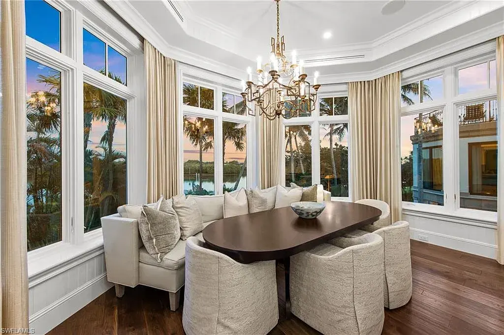 3675 Gordon Dr luxury home in Naples featuring French West Indies design, private beach access, koi pond, resort-style pool, and Gulf-access dock.