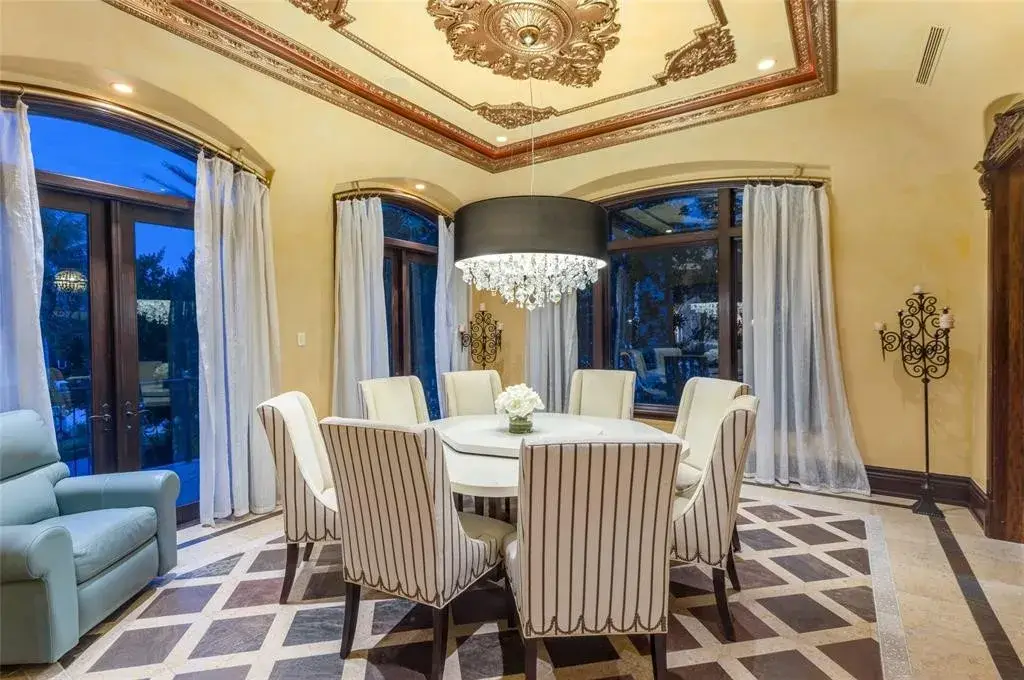 Elegant living room at 2306 Bay Dr featuring marble floors, high ceilings, and panoramic ocean views
