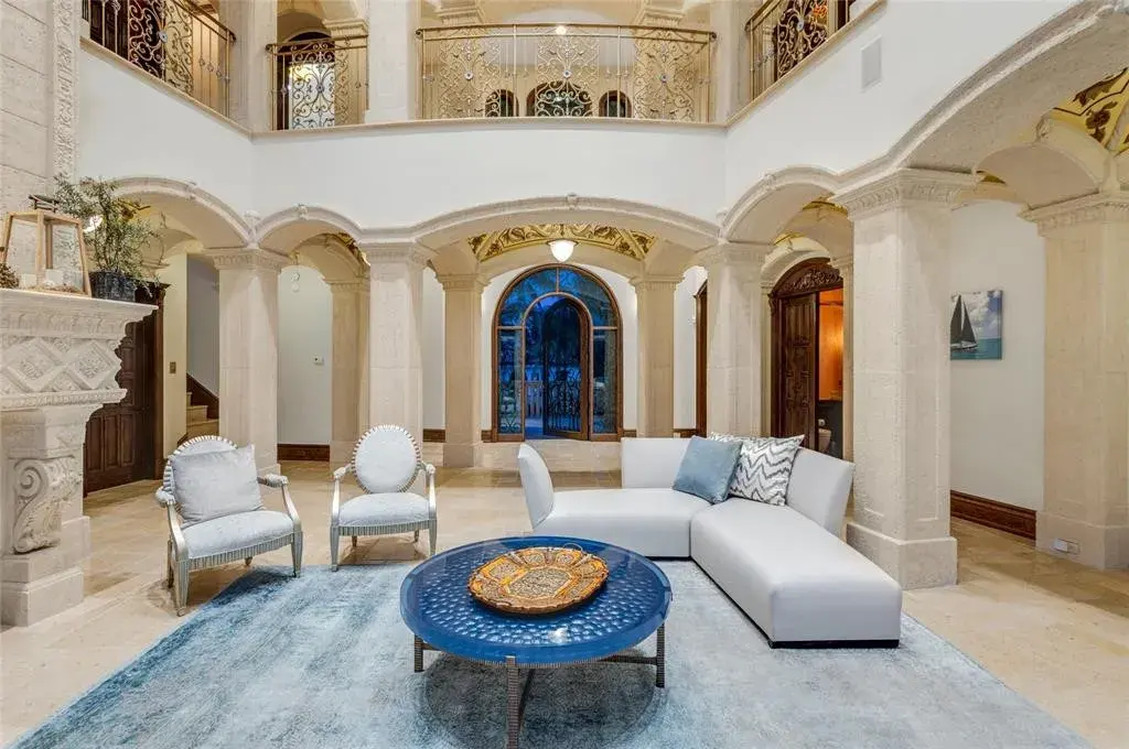 Elegant living room at 2306 Bay Dr featuring marble floors, high ceilings, and panoramic ocean views