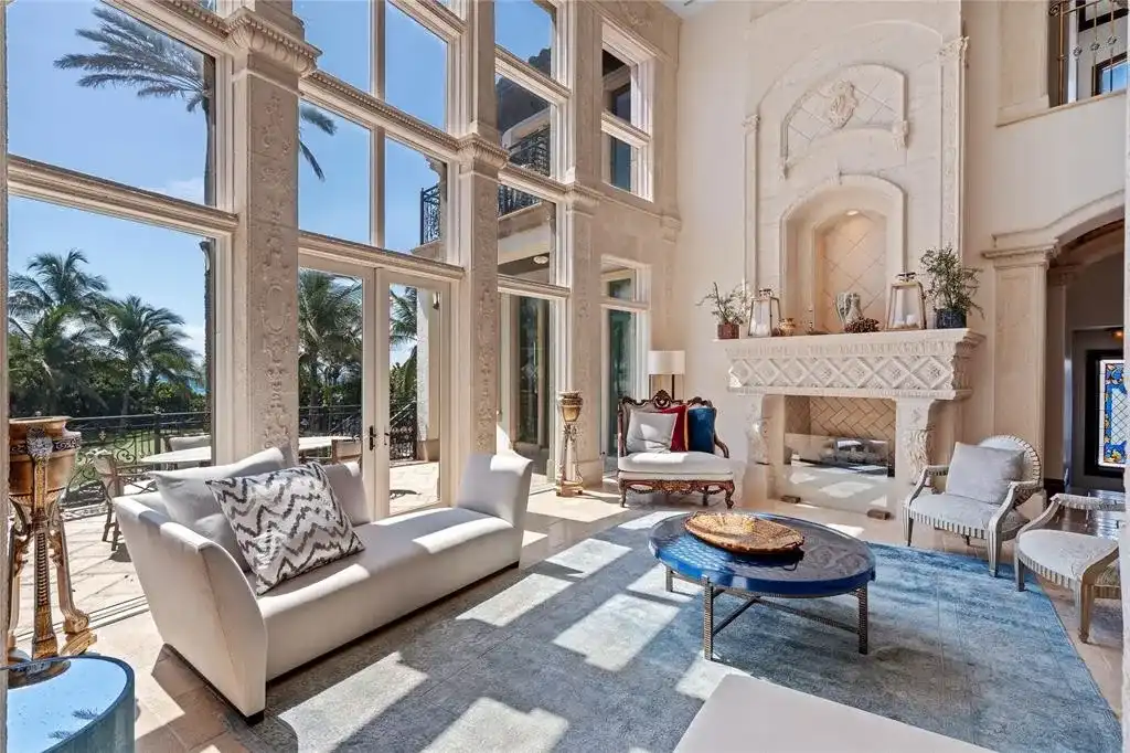 Elegant living room at 2306 Bay Dr featuring marble floors, high ceilings, and panoramic ocean views