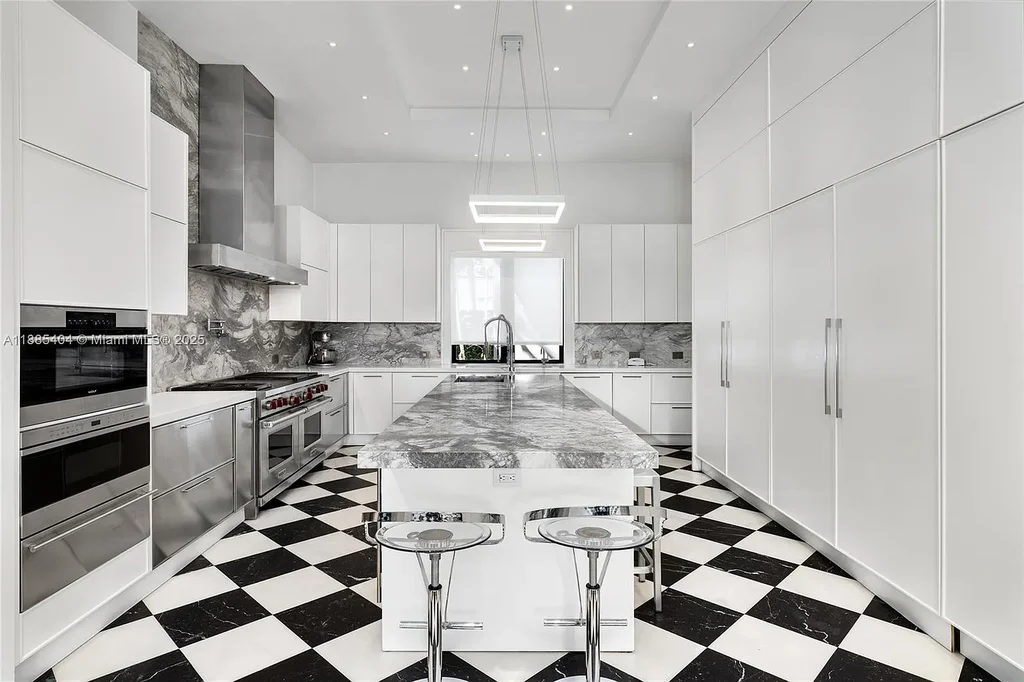 Luxury Mediterranean waterfront estate at 231 Costanera Road Coral Gables with private dock, $11.98M home featuring pool, lush landscaping, and elegant design