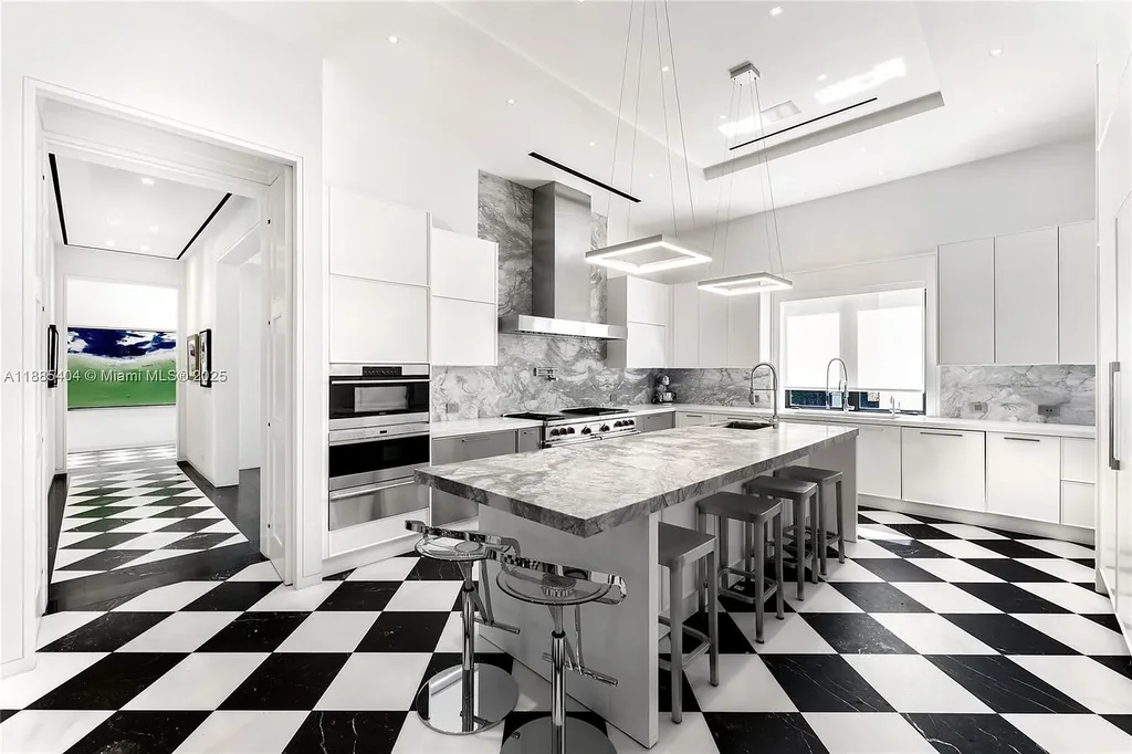 Luxury Mediterranean waterfront estate at 231 Costanera Road Coral Gables with private dock, $11.98M home featuring pool, lush landscaping, and elegant design