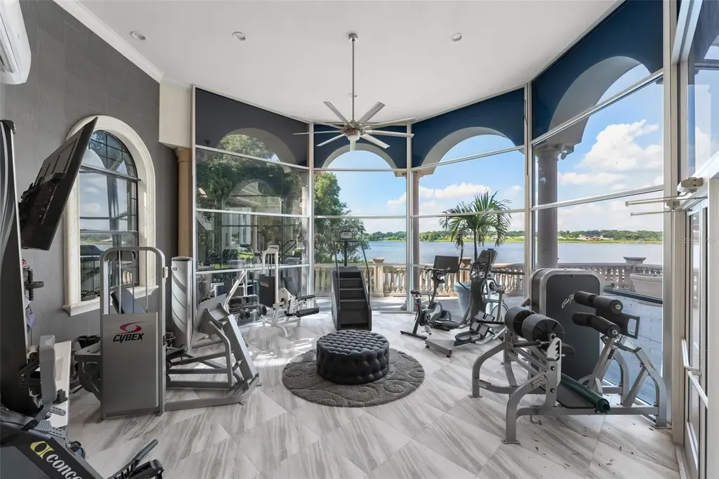 Spacious marble-floor living room with soaring ceilings and lake views inside 9639 Westover Roberts Rd luxury home in Windermere FL