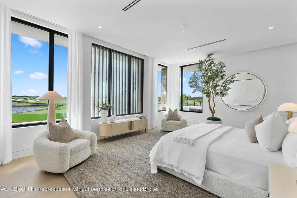 Front view of 10967 Monte Rosa Dr in Palm Beach Gardens, a $9.6 million modern golf estate by architect Max Strang featuring glass facades, terraces, and lake views.