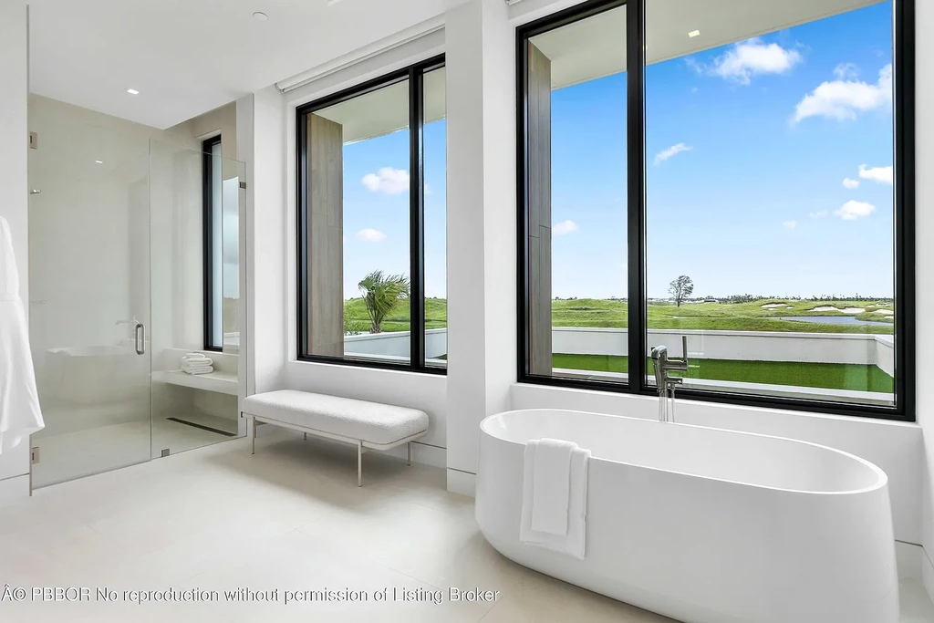 Front view of 10967 Monte Rosa Dr in Palm Beach Gardens, a $9.6 million modern golf estate by architect Max Strang featuring glass facades, terraces, and lake views.