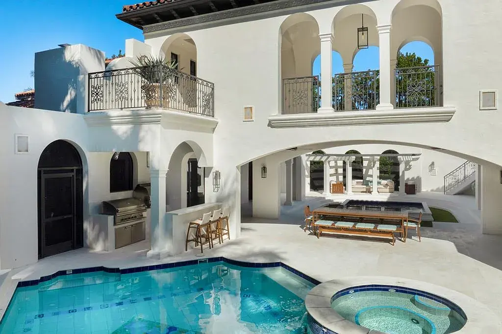 Front view of 21 S Bridge Ln Key Largo FL luxury waterfront estate with tropical landscaping