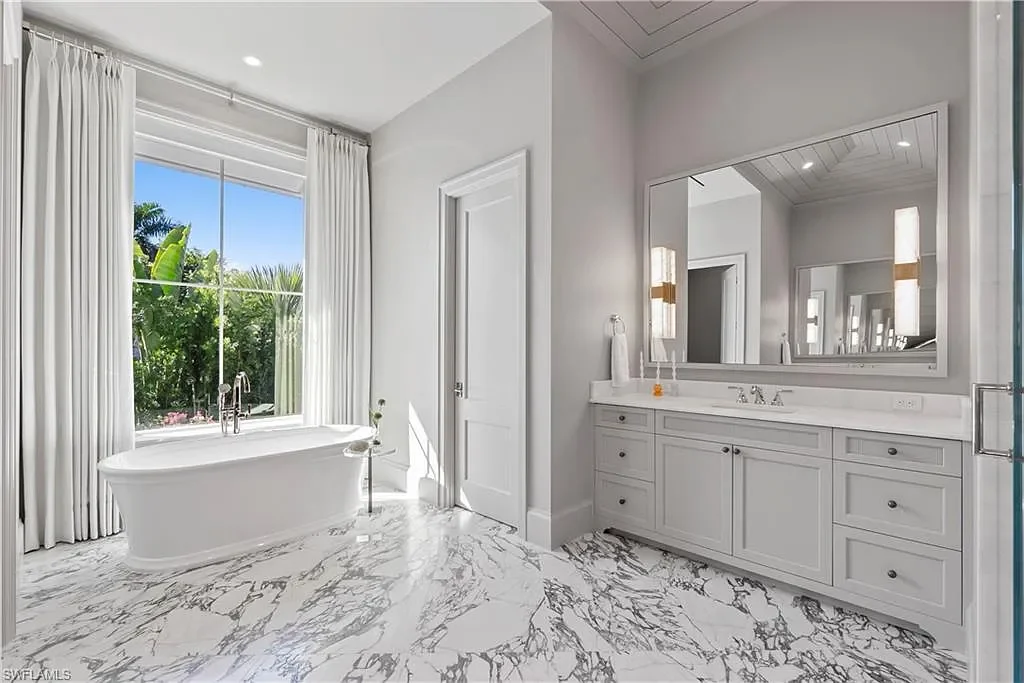 Luxury coastal home at 285 Central AVE Naples FL with pool, outdoor kitchen, and elegant modern interiors.