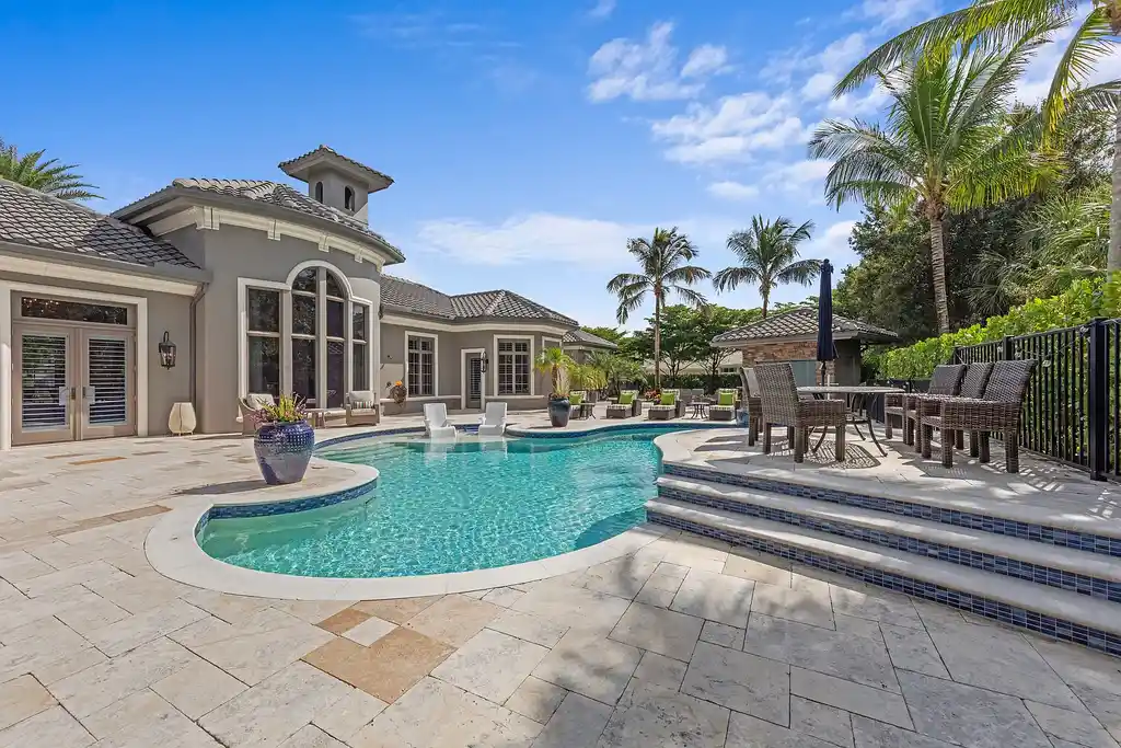 Exterior view of 4517 Brynwood DR Naples FL luxury estate with resort-style pool and landscaped gardens