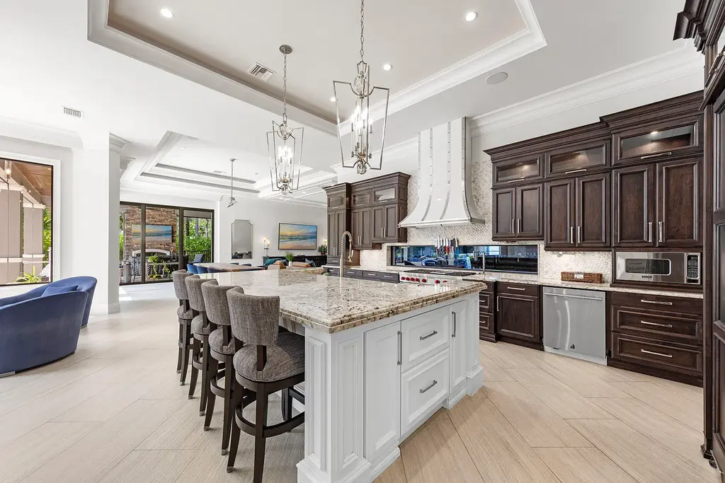 Exterior view of 4517 Brynwood DR Naples FL luxury estate with resort-style pool and landscaped gardens