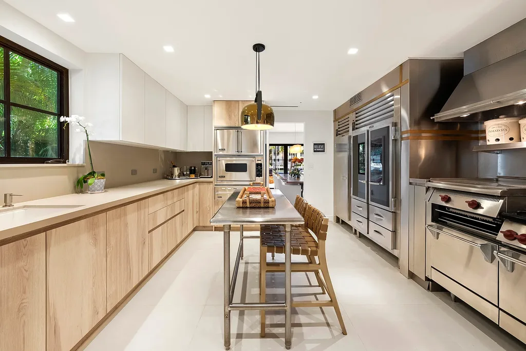 Mediterranean Revival living room with arched windows and coastal interiors at 6065 Pine Tree Dr