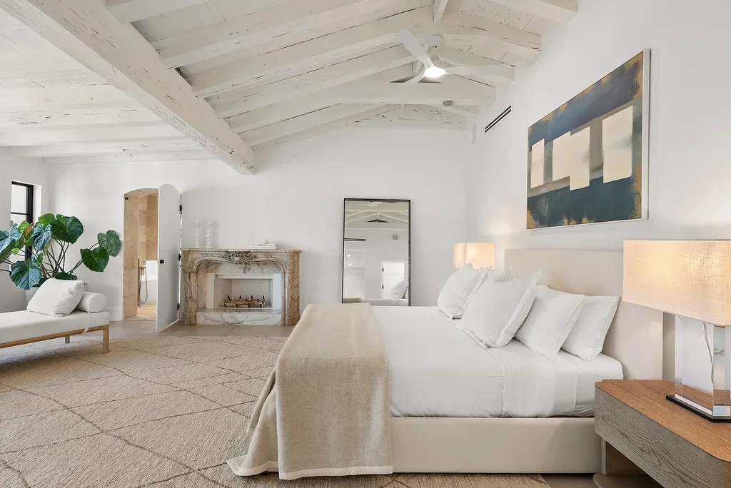 Mediterranean Revival living room with arched windows and coastal interiors at 6065 Pine Tree Dr