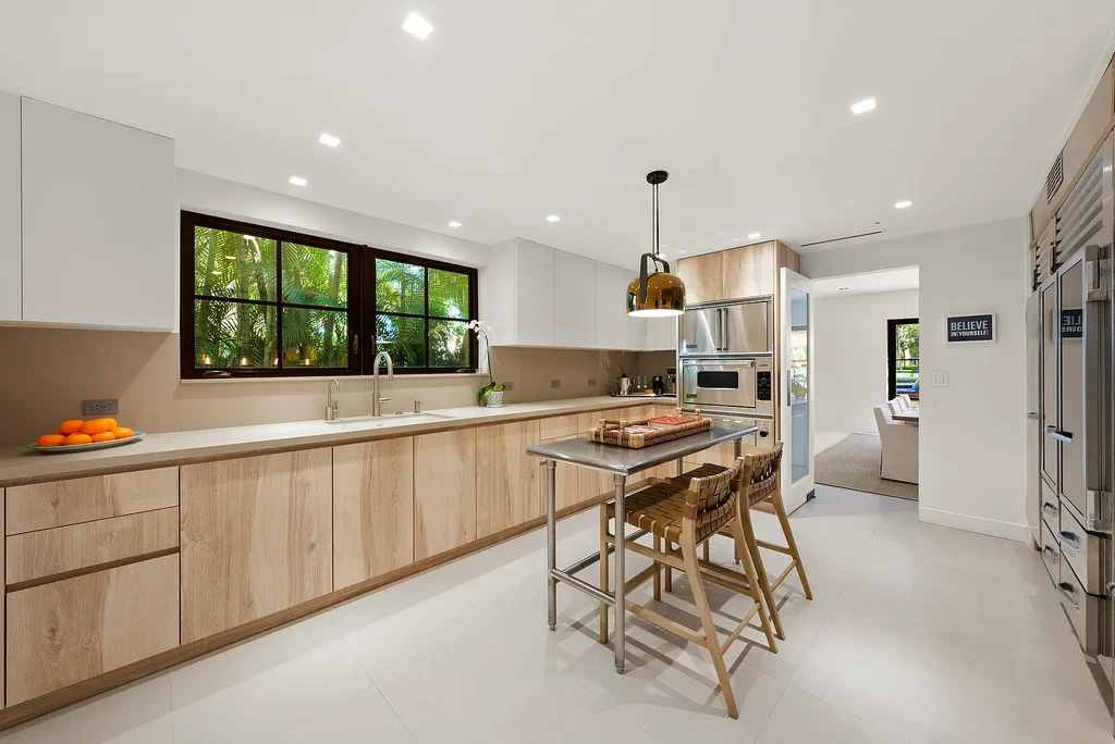 Mediterranean Revival living room with arched windows and coastal interiors at 6065 Pine Tree Dr