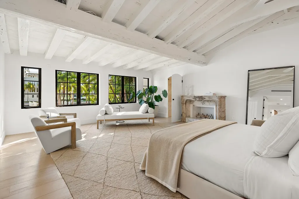 Mediterranean Revival living room with arched windows and coastal interiors at 6065 Pine Tree Dr