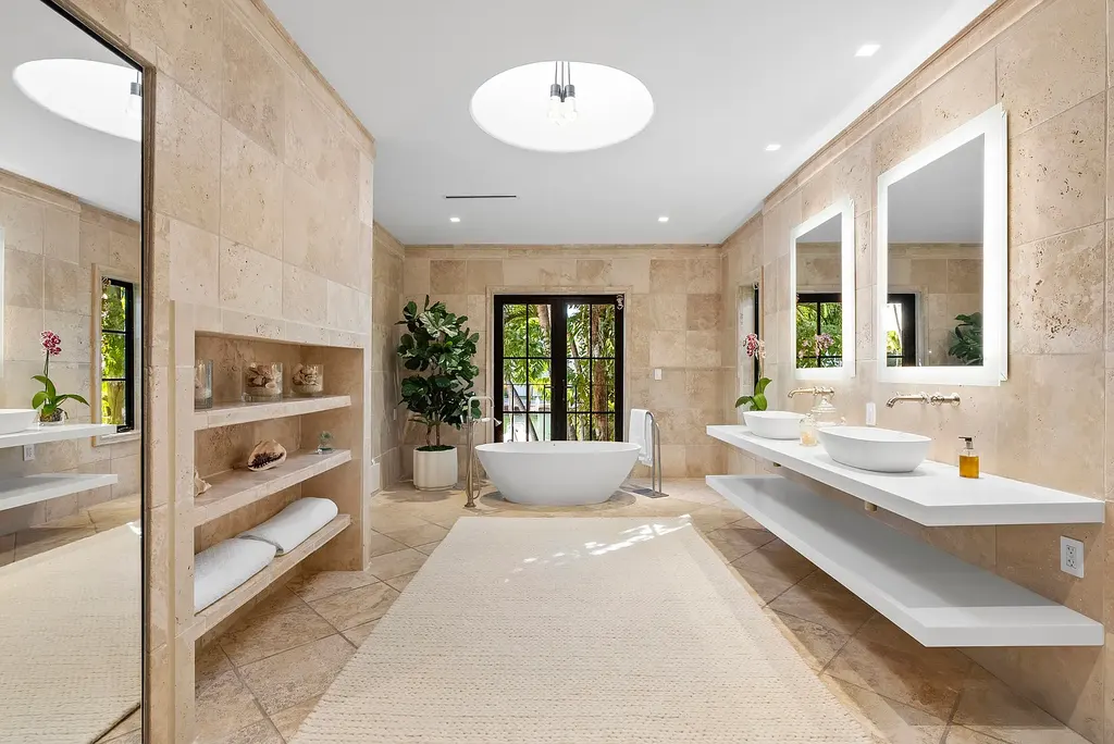 Mediterranean Revival living room with arched windows and coastal interiors at 6065 Pine Tree Dr