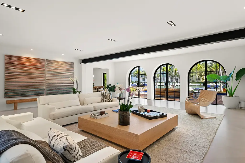 Mediterranean Revival living room with arched windows and coastal interiors at 6065 Pine Tree Dr